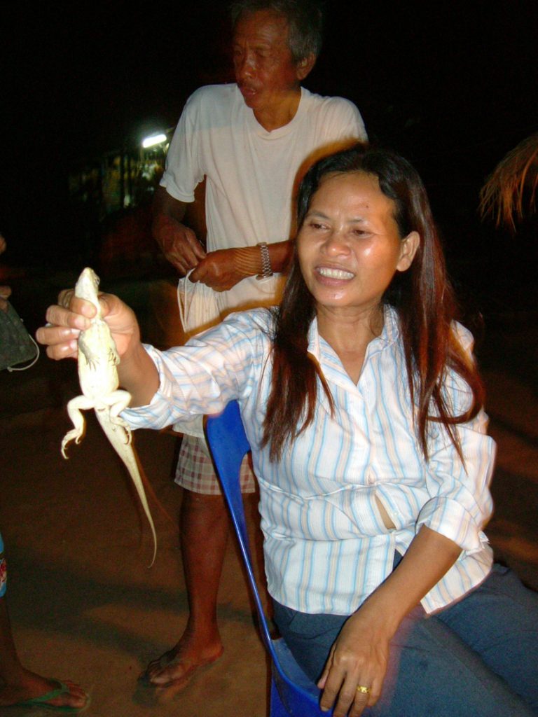 Girl holding up lizard 