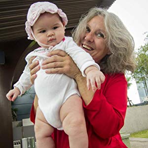 Author holding up her grandchild